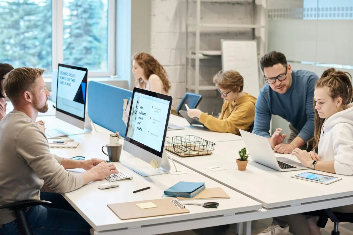 Team working at modern office desks after a new IT setup